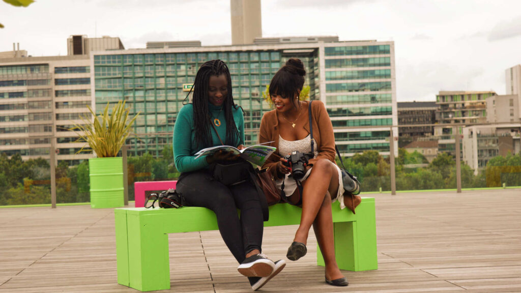 two ladies on tour seating on a bench